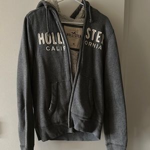 Gray fleece lined holistic sweater with pockets and hood